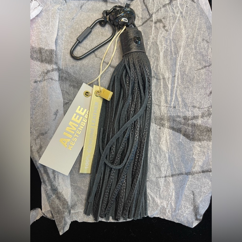 Aimee Kestenberg black leather tassel with black heart hardware.